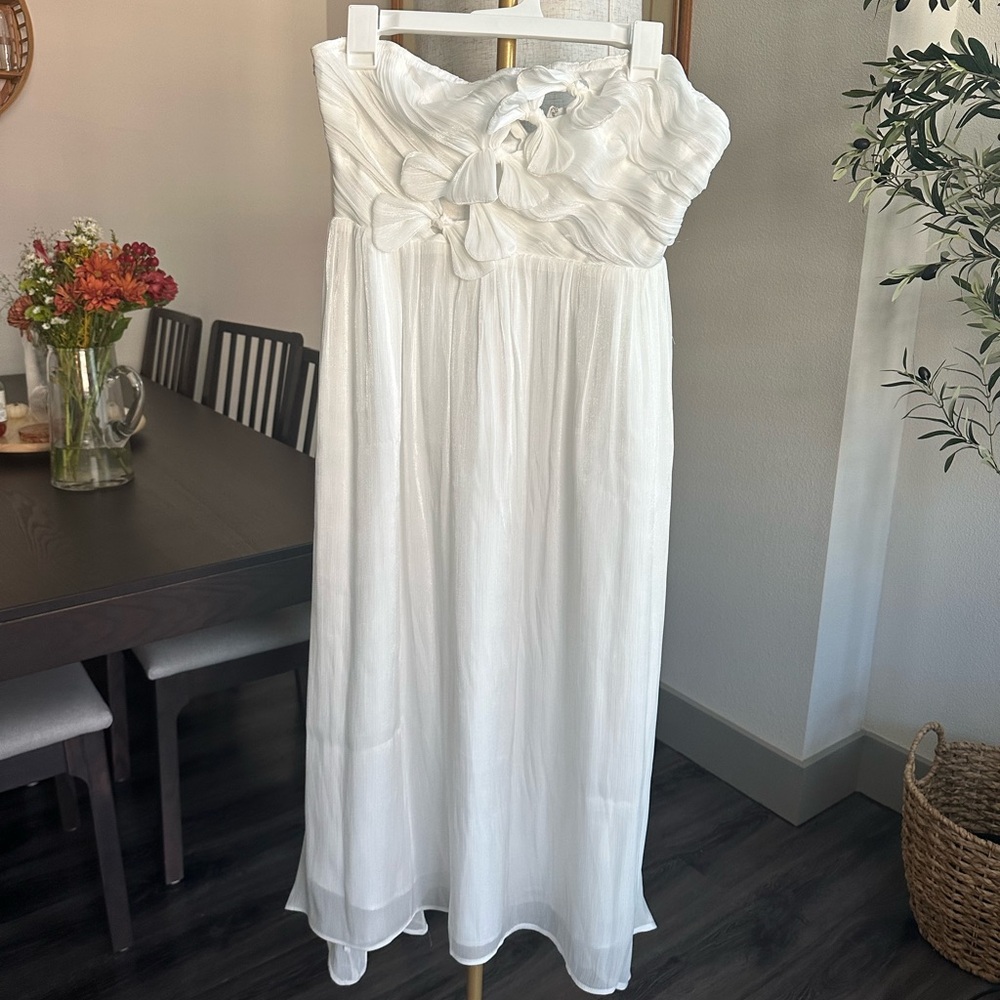 This white dress is perfect for any occasion, especially for brides. Never worn.